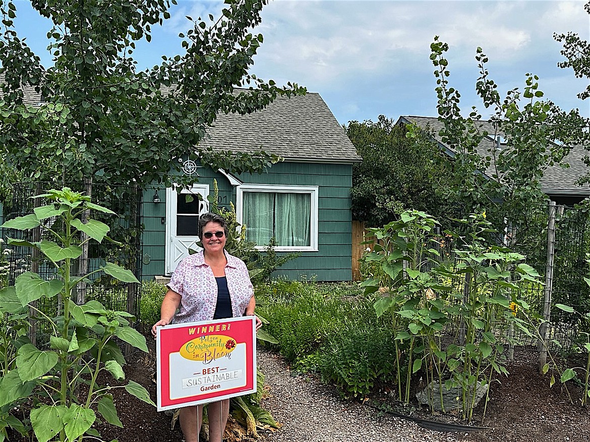 Tam Newby was honored for her sustainable garden on Fifth Ave. E. by judges from the Polson Beautification Committee.