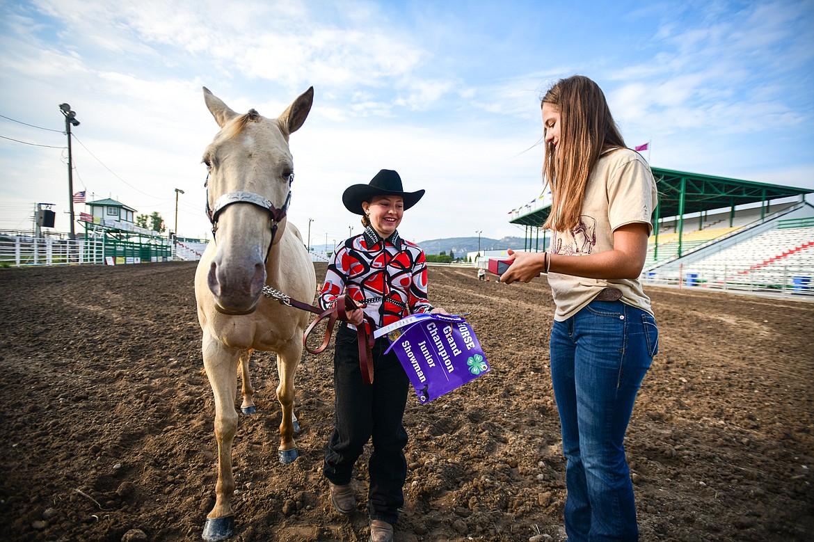 Sidni Sorensen receives her grand champion ribbon and belt buckle in pre-junior level showmanship at the 4H Horse Show at the Northwest Montana Fair on Saturday, Aug. 10. (Casey Kreider/Daily Inter Lake)