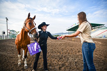 Addy Aiken receives her grand champion ribbon and belt buckle in junior level showmanship at the 4H Horse Show at the Northwest Montana Fair on Saturday, Aug. 10. (Casey Kreider/Daily Inter Lake)