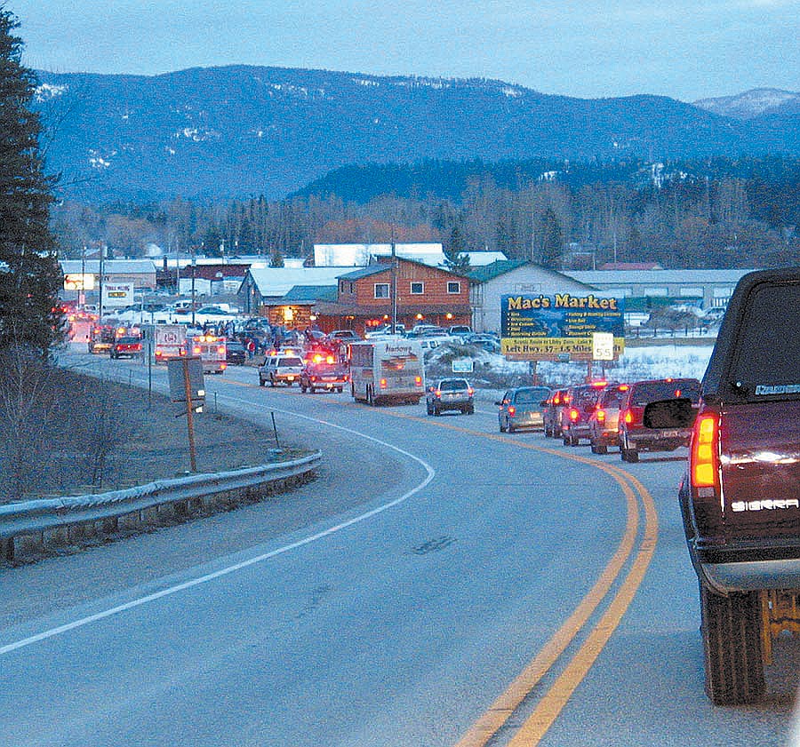 The Libby Logger team bus and parade of cars as the team enters Libby on their return from the state championship in 2004. (Western News photo)