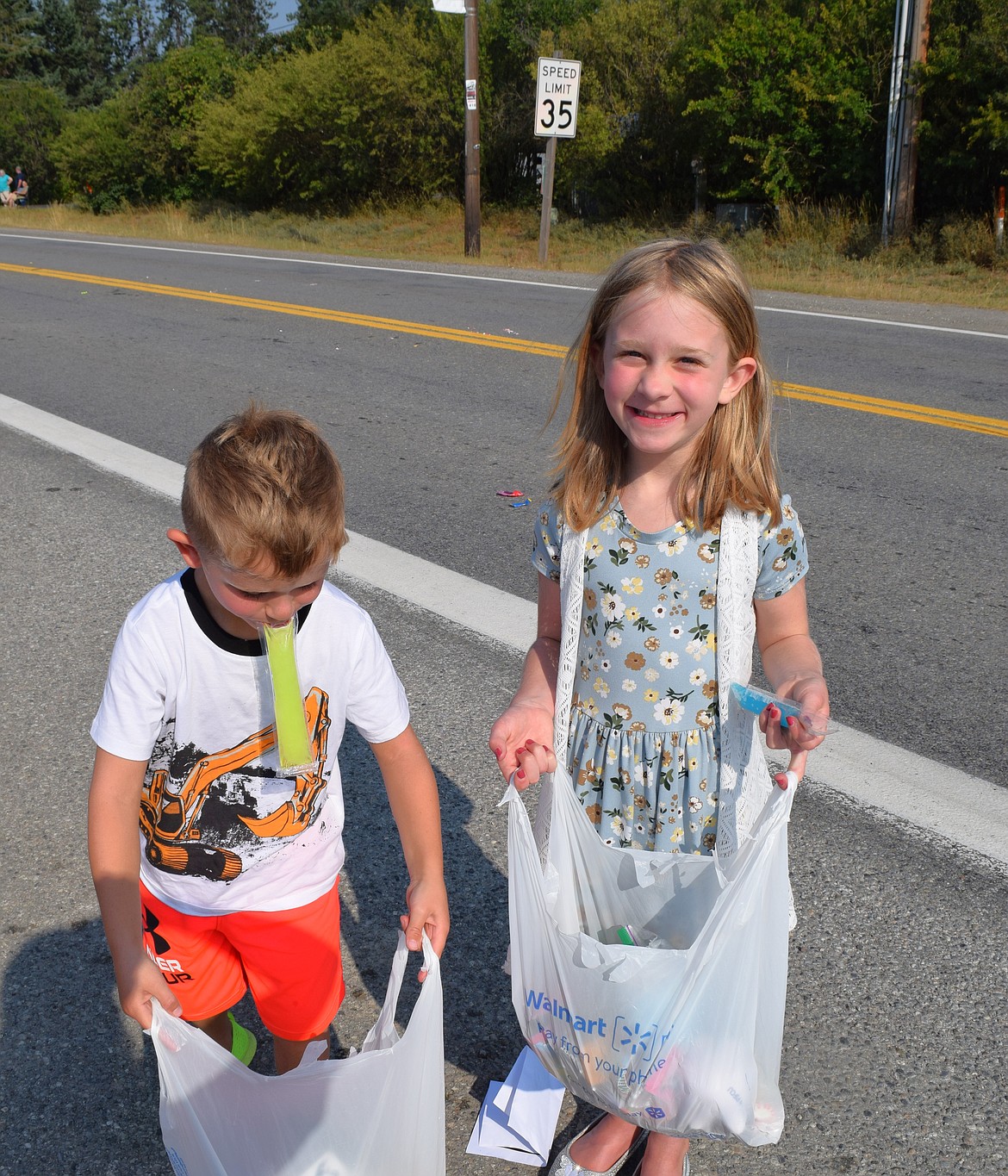 Adalynn and Walter Syth show off their candy haul after the parade, but Walter is a bit preoccupied with his popsicle given to him by the fire department.