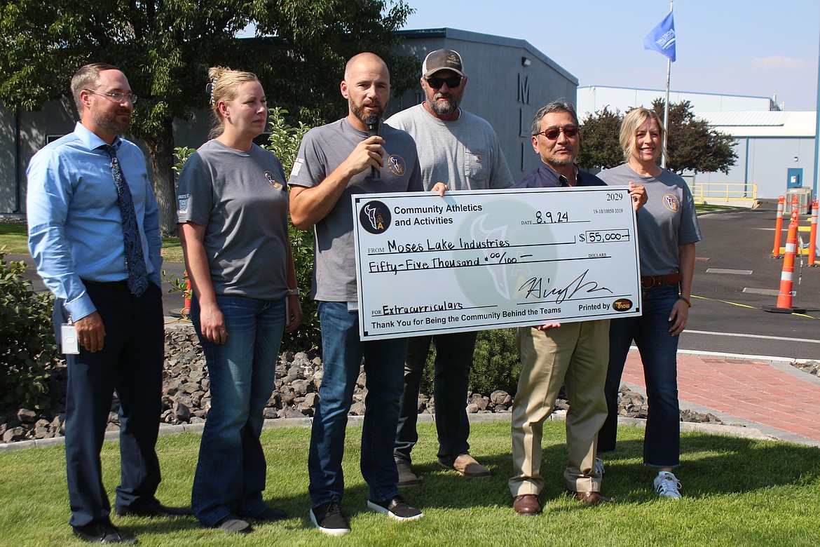 Moses Lake Industries President Hiroyuki Era, second from right, presents a donation to Community Athletics and Activities board members. From left: Jeremy Huberdeau, Cody Parrish, Ryan Carpenter, James Getzinger and Eva Olson.