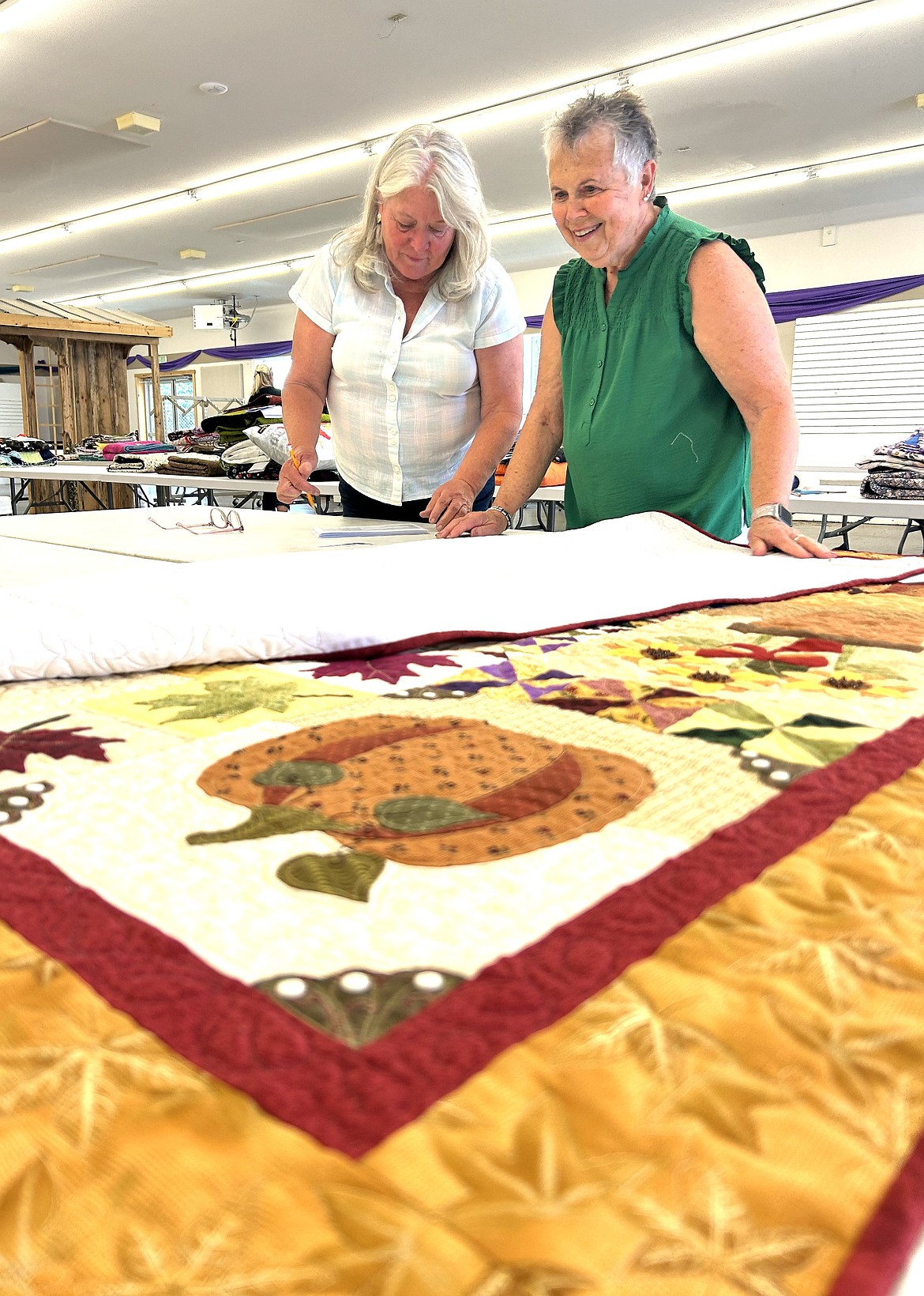 Wendy Sienknecht and Donna Gibson judge a quilt entry for the North Idaho State Fair.