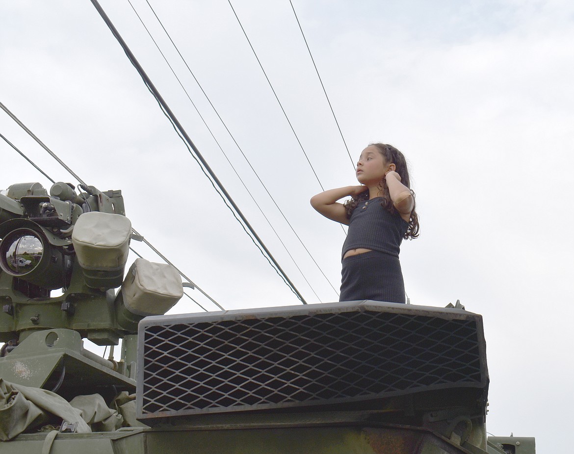 Six-year-old Analeah Esquivel surveys the world from the top of the Moses Lake Tactical Response Team’s armored vehicle at National Night Out in Mattawa Friday.