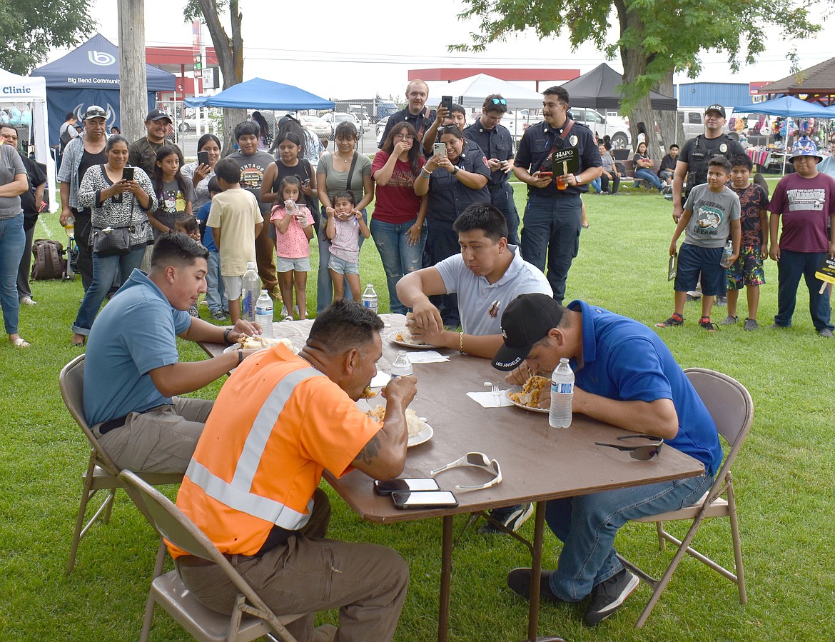 First responders chow down on three-pound burritos in the Belly Busting Burrito contest at National Night Out Friday in Mattawa.