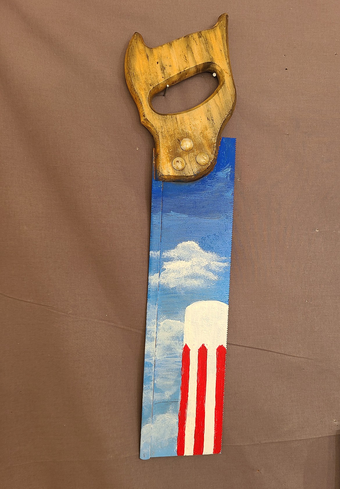 Nellie Hoot honored her adopted hometown of Othello by painting its iconic water tower on an antique handsaw.