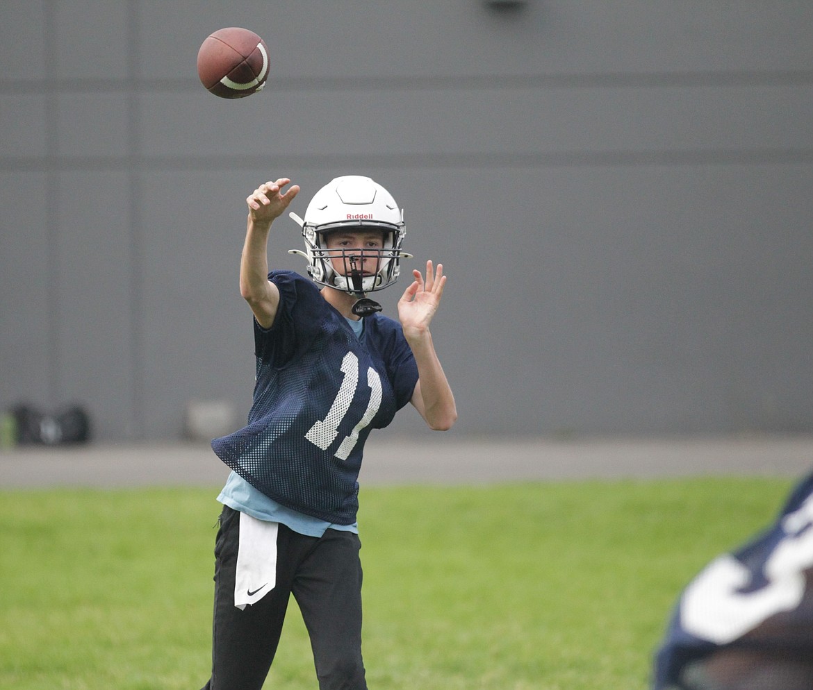 MARK NELKE/Press
Coeur du Christ freshman quarterback Grant Clemens (11) throws a pass during practice Monday morning at Holy Family Catholic School in Coeur d'Alene. After two years of being an associate member of the Idaho High School Activities Association, Coeur du Christ, a school with grades 9-12 and roughly 60 students, has become a full member of the IHSAA this school year, and is starting a football program this year. The Saints, who compete in the new class 1A (the smallest of Idaho's six classifications), also offer volleyball and boys basketball, which played as associate members the past two years. Coeur du Christ's first football game is Aug. 23 at 7 p.m. vs. Lakeside at the Marimn Health Coeur Center in Worley.