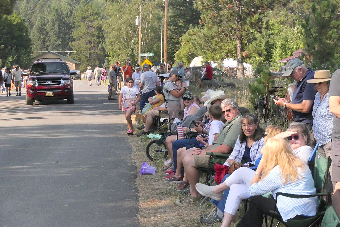 Festival goers line the street coming one of the park where this year's Huckelberry Festival in Trout Creek was held. Several thousand people thronged to the town for the festival's two-day run. (Chuck Bandel/VP-MI)