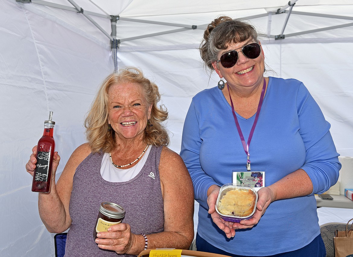 Beta Sigma Phi sorority members Bevy Flood and Kris Queen help sell huckleberry baked goods at the Huckleberry Days Art Festival. Money raised from the sorority's bake sale go towards a scholarship that is given to a Whitefish High School student every year. (Kelsey Evans/Whitefish Pilot)