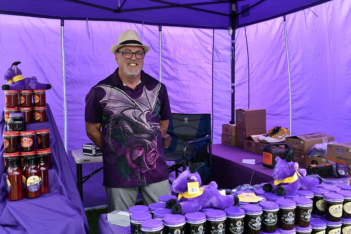 Dave Thompson from Hungry Horse decks out The Galivinating Goat’s huckleberry food stand in all purple at the Huckleberry Days Art Festival. (Kelsey Evans/Whitefish Pilot)