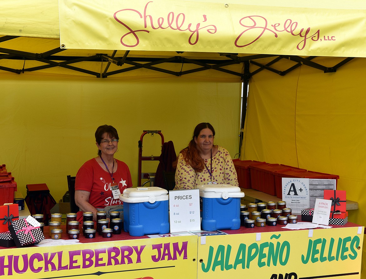 Ruth Naldrett and Shelly Naldrett from family-run Shelly's Jellys in Kalispell offer up sweet, savory and even spicy varieties of huckleberry jams at the Huckleberry Days Art Festival in Depot Park. The Shelly's Jellys booth has been at the same corner of the festival for years. (Kelsey Evans/Whitefish Pilot)