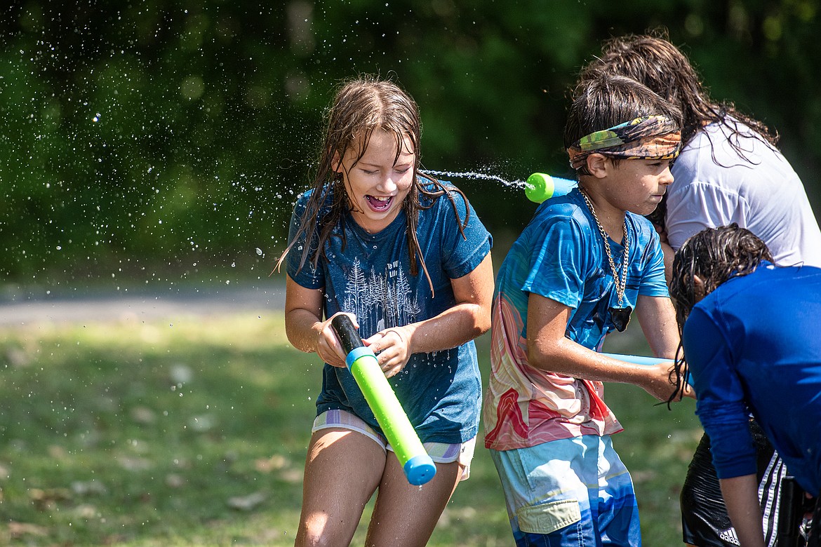 Kids have a water fight during the Swan Lake Huckleberry Festival Saturday, August 10. (Avery Howe/Bigfork Eagle)