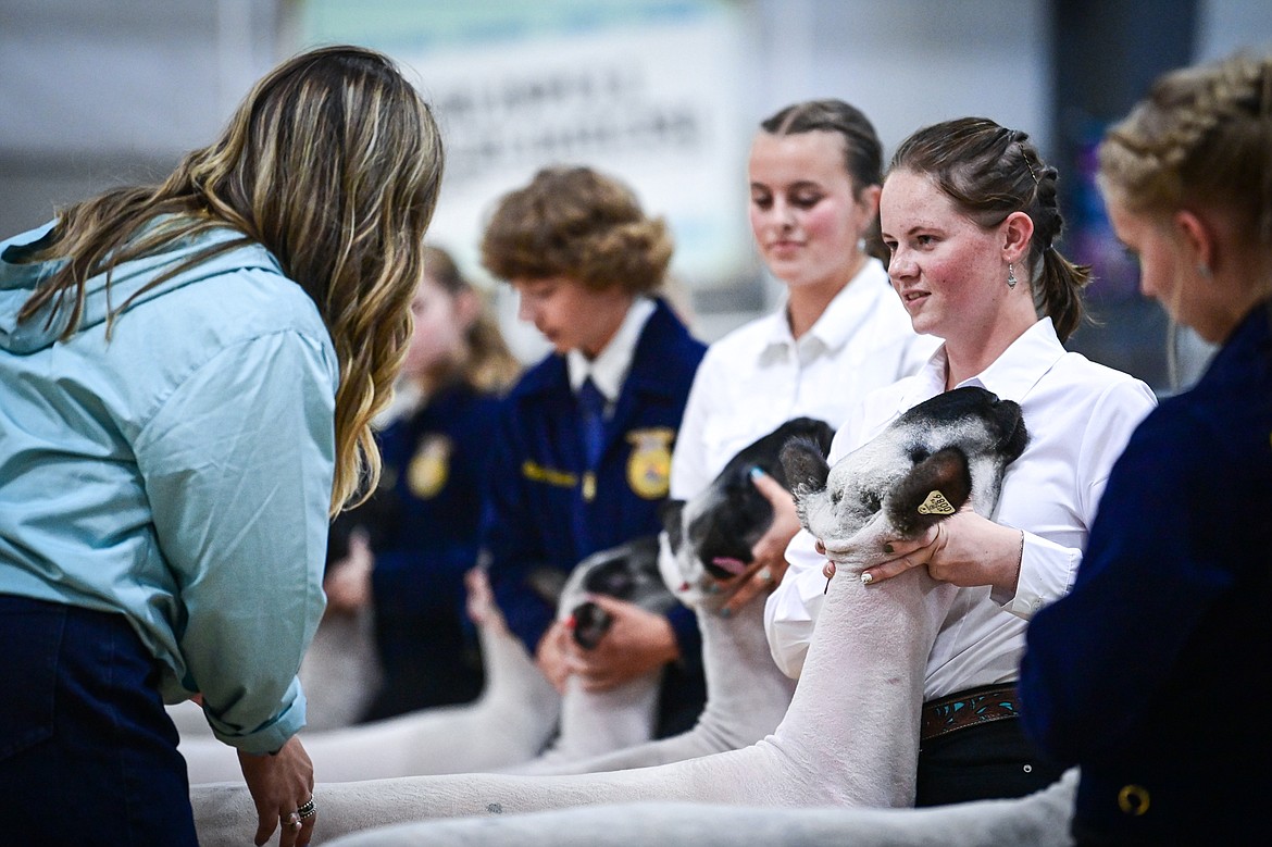 Judge Sierra Myers speaks with contestants during senior sheep showmanship at the Northwest Montana Fair on Tuesday, Aug. 13. (Casey Kreider/Daily Inter Lake)