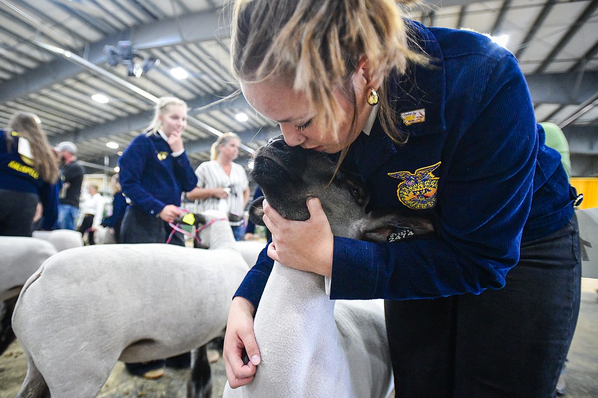 Laila Sargeant gives her sheep a kiss before the start of senior sheep showmanship at the Northwest Montana Fair on Tuesday, Aug. 13. Sargeant won grand champion in her division. (Casey Kreider/Daily Inter Lake)