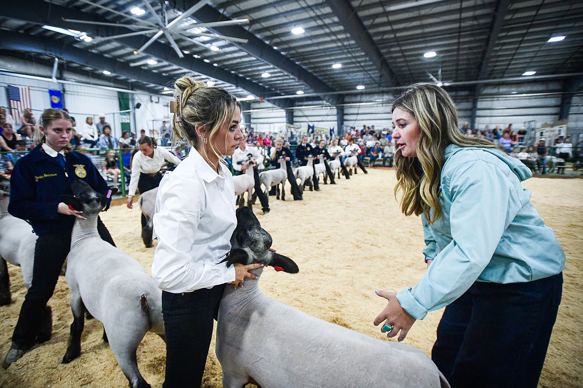 Judge Sierra Myers speaks with contestants during senior sheep showmanship at the Northwest Montana Fair on Tuesday, Aug. 13. (Casey Kreider/Daily Inter Lake)