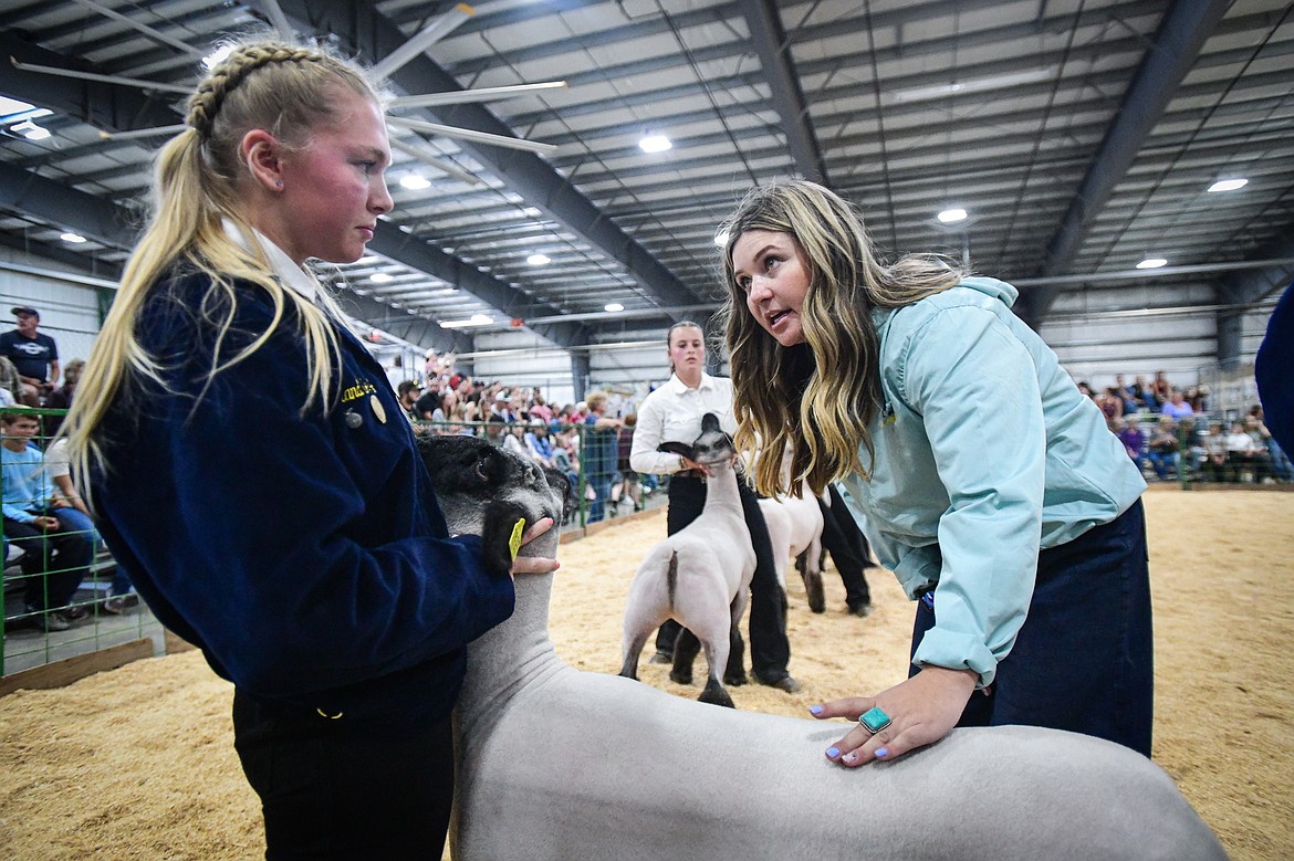 Judge Sierra Myers speaks with Cazzland Rankosky during senior sheep showmanship at the Northwest Montana Fair on Tuesday, Aug. 13. (Casey Kreider/Daily Inter Lake)