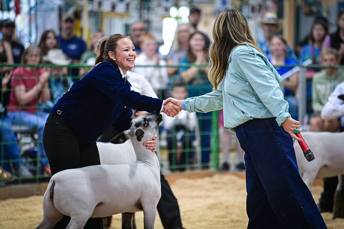 Laila Sargeant shakes the hand of judge Sierra Myers after Myers awarded her grand champion during senior sheep showmanship at the Northwest Montana Fair on Tuesday, Aug. 13. (Casey Kreider/Daily Inter Lake)