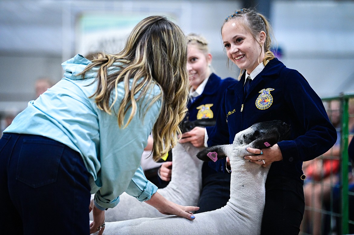 Judge Sierra Myers speaks with Paige Morrison during senior sheep showmanship at the Northwest Montana Fair on Tuesday, Aug. 13.  (Casey Kreider/Daily Inter Lake)