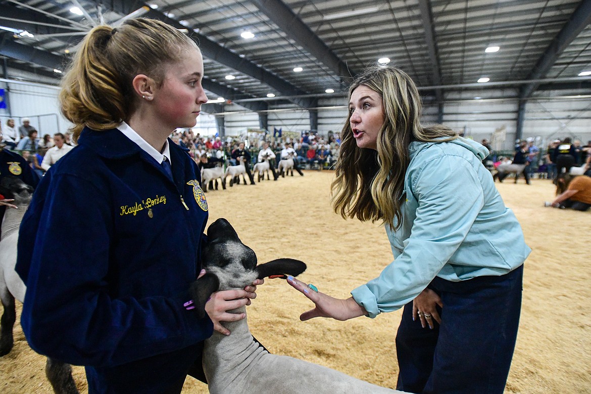 Judge Sierra Myers speaks with Kayla McConkey during senior sheep showmanship at the Northwest Montana Fair on Tuesday, Aug. 13. (Casey Kreider/Daily Inter Lake)