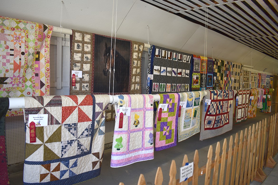 Quilts cover the walls of the Home Economics Building at the Grant County Fair Tuesday.