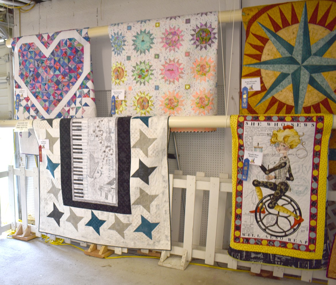 Some of the quilts on display at the Grant County Fair Tuesday were quite intricate, including a compass rose, a musical motif and a stylized unicycle rider with the words “She who sews will also reap.”