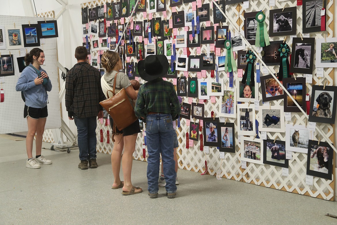 Area residents look at the photography entries at the Bonner County Fair on Tuesday.