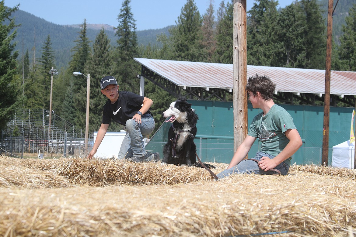 Gabe Otis and friend Oliver Gish hang out at the top of the hay bale maze on Tuesday as the Bonner County Fair kicked off a week of activities, critters and fun — and a celebration of the community's country roots.