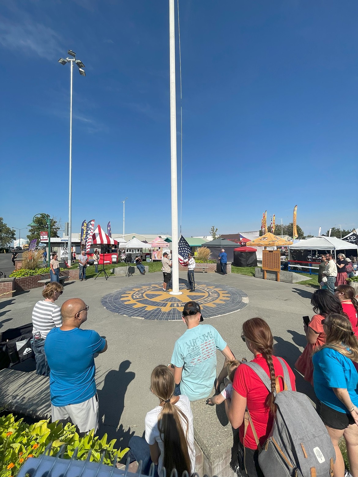 Jim Beck and Norm Kieth from American Legion Post 209 attach the American Flag and the Grant County Fair flag to the pole in the middle of the fairgrounds during the opening ceremony. The two have been raising the flag for a handful of years.