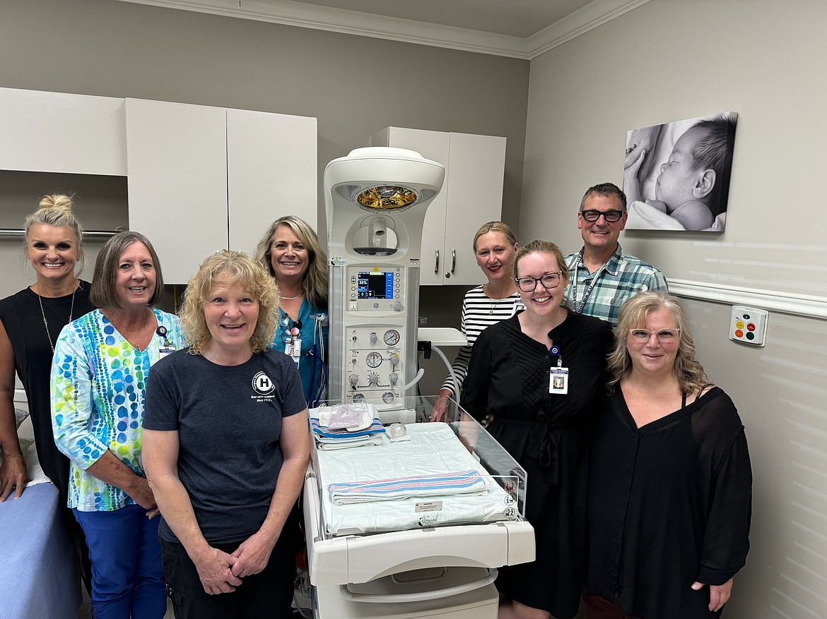 Newport Hospital and Health Services Foundation and hospital staff pose for a photo with one of the new infant warmers donated to the Newport hospital. Pictured in the front row, from left are Terri Ivie, foundation secretary, and Jenny Cooper, foundation board. Pictured in the middle row, from left, are Kim Manus, CFO and foundation board; and Taylor Stewart, MD. Pictured in the back row, from left, are foundation supervisor Lori Stratton, obstetrics coordinator Erin Miller, RN, BSN; Merry-Ann Keane, MSN, BSN, NE-BC, FACHE, hospital CEO and foundation president; and chief nursing officer, Benjamin Schultze, PhD, MSN, M.Ed, APRN.