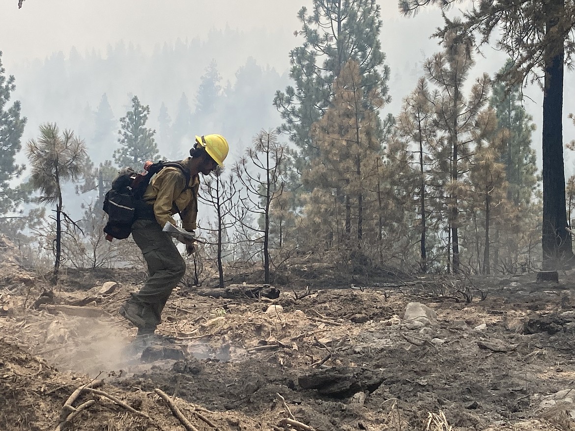 A firefighter works on mopping up areas of the Retreat Fire. The fire is increasing in containment daily however it has burned 45,600 acres and is the largest active Washington fire.