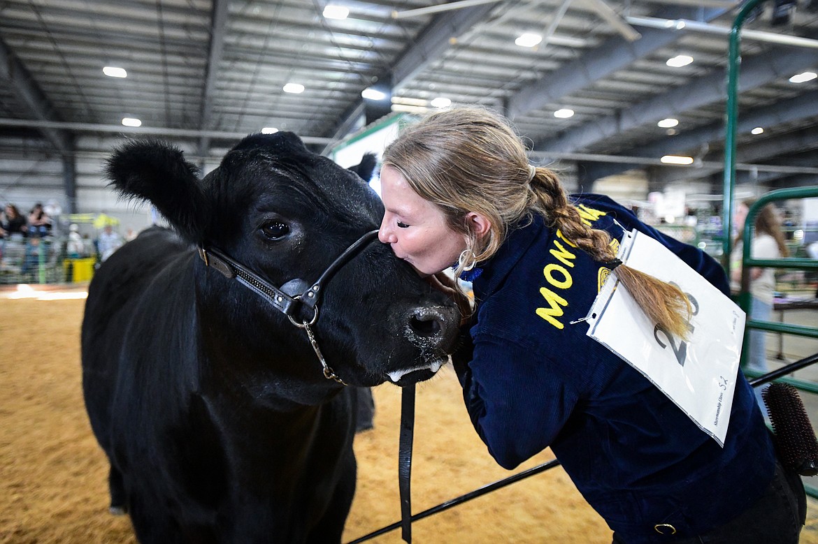 Brady Boll gives her steer a kiss after winning grand champion in senior beef cattle showmanship at the Northwest Montana Fair on Wednesday, Aug. 14. (Casey Kreider/Daily Inter Lake)