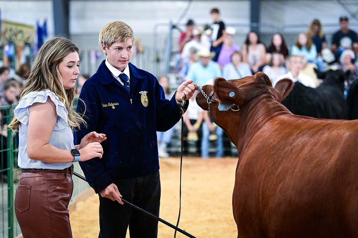 Beau Siderius speaks with judge Sierra Myers during senior beef cattle showmanship at the Northwest Montana Fair on Wednesday, Aug. 14. (Casey Kreider/Daily Inter Lake)