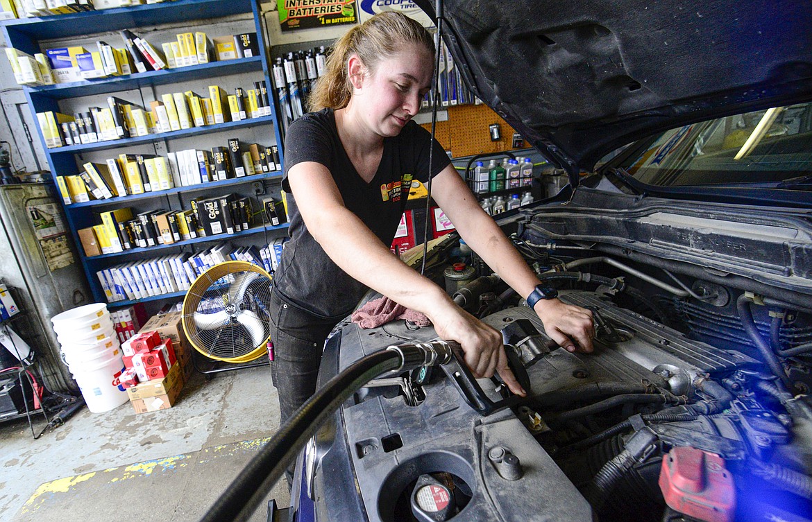 Elise Lacroix, owner of Stop & Go in Brattleboro, Vt., changes the oil on a vehicle at her shop on July 15, 2024. (Kristopher Radder/The Brattleboro Reformer via AP, File)