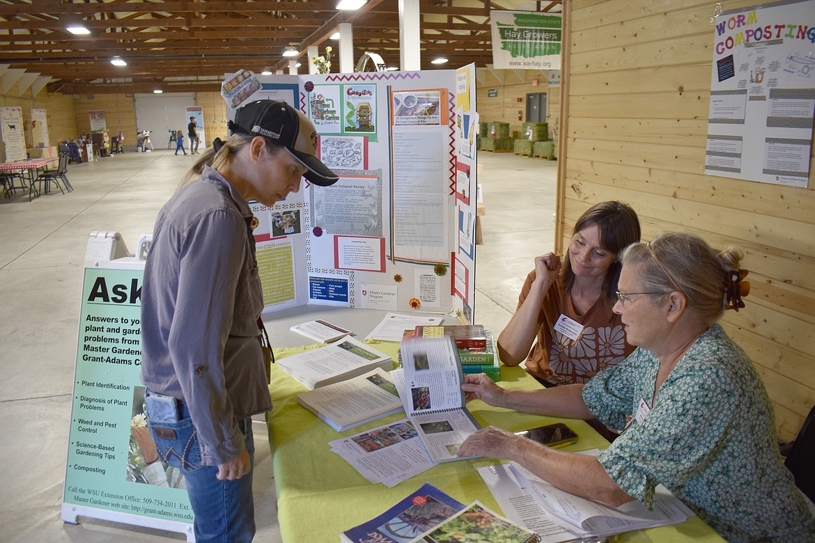 Carmen Rimple, left, talks with WSU Grant-Adams Master Gardeners Bobbie Bodenman and Mary Love about desert-friendly native plants for Rimple’s lawn. The master gardeners have held a plant clinic at the Grant County Fair all week, answering questions and offering gardening tips.