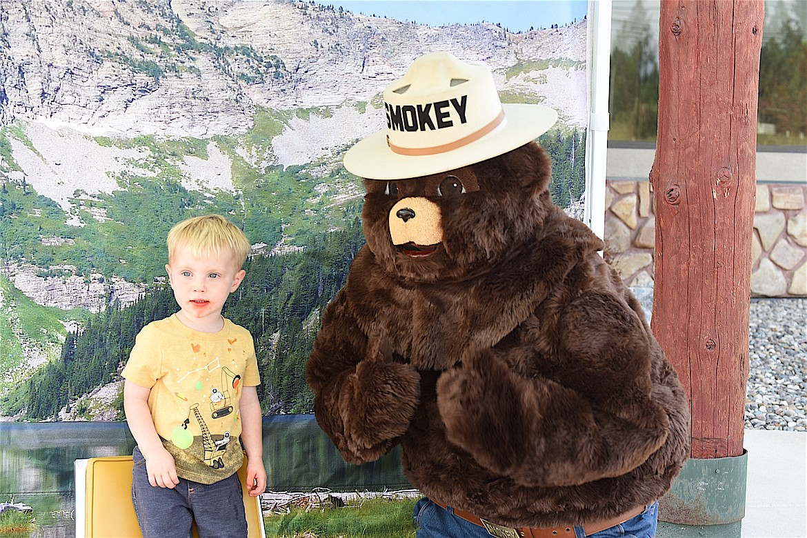 Drake Higareda helped Smokey Bear celebrate his 80th birthday Friday, Aug. 9, 2024, at Kootenai National Forest headquarters in Libby. (Scott Shindledecker/The Western News)