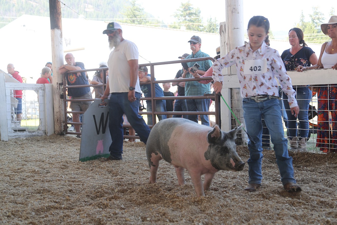 Scarlett Laub, a member of the Sagle Saddle Tramps 4-H Club, guides her pig around the arena during the Bonner County Fair on Wednesday.