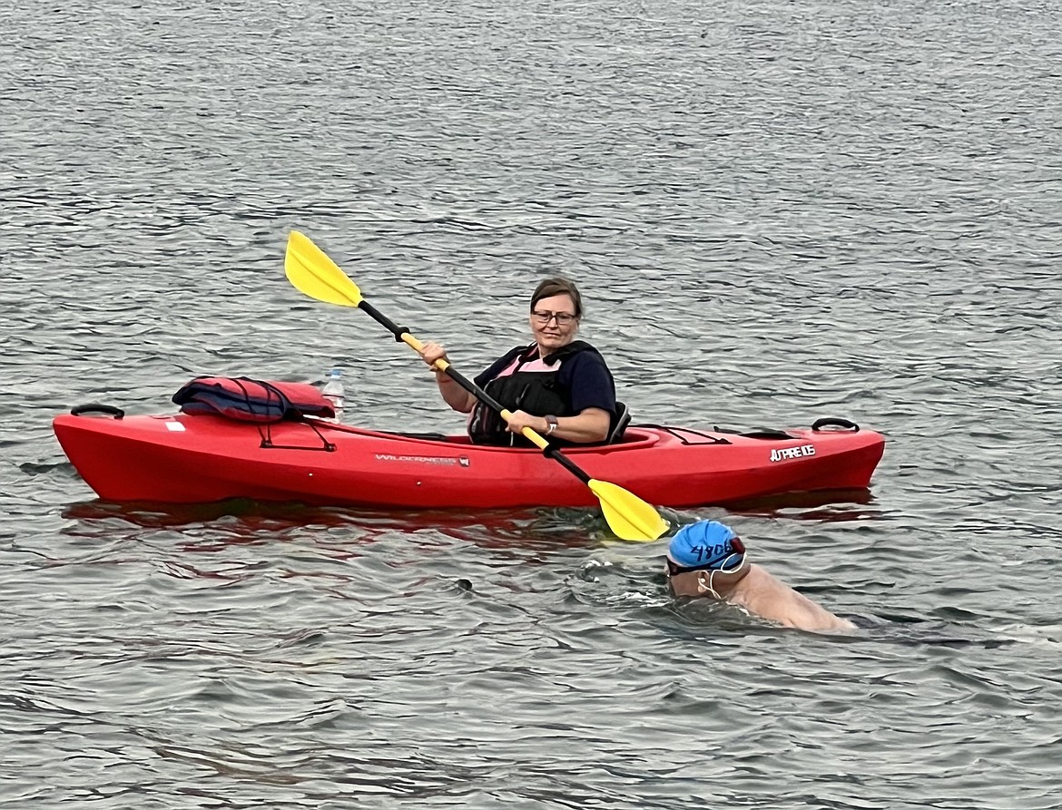 Lane Henderson and the kayaker who assisted him in his trek, Laurie, near the Long Bridge Swim finish.