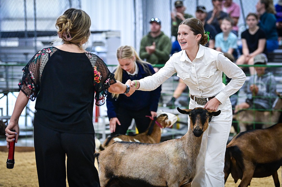 Ella Labrum shakes the hand of judge Sierra Meyers after Meyers awarded her grand champion in senior goat showmanship at the Northwest Montana Fair on Thursday, Aug. 15. (Casey Kreider/Daily Inter Lake)