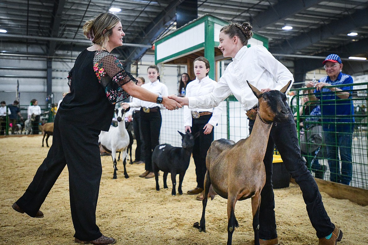 Naomi Brist shakes the hand of judge Sierra Meyers after she won grand champion in junior goat showmanship at the Northwest Montana Fair on Thursday, Aug. 15. (Casey Kreider/Daily Inter Lake)