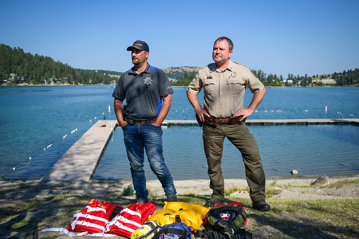 Flathead County Sheriff Brian Heino and Montana Fish, Wildlife & Parks Warden Captain Nathan Reiner discuss water safety practices at Foys Lake County Park on Thursday, Aug. 15. (Casey Kreider/Daily Inter Lake)