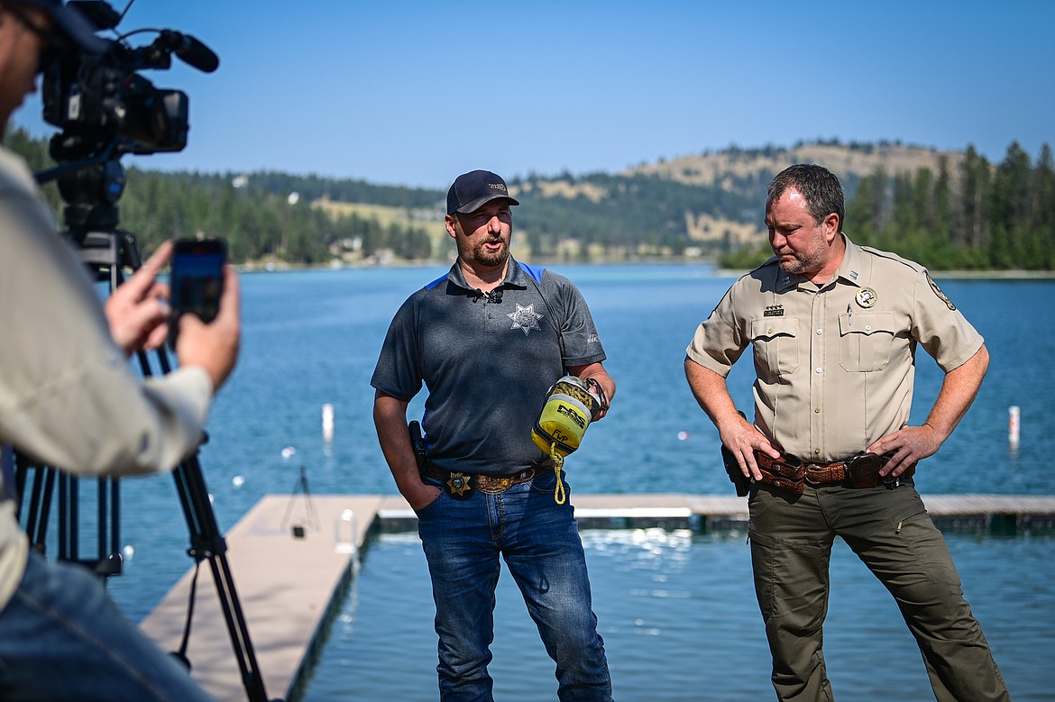 Flathead County Sheriff Brian Heino and Montana Fish, Wildlife & Parks Warden Captain Nathan Reiner discuss water safety practices at Foys Lake County Park on Thursday, Aug. 15. (Casey Kreider/Daily Inter Lake)