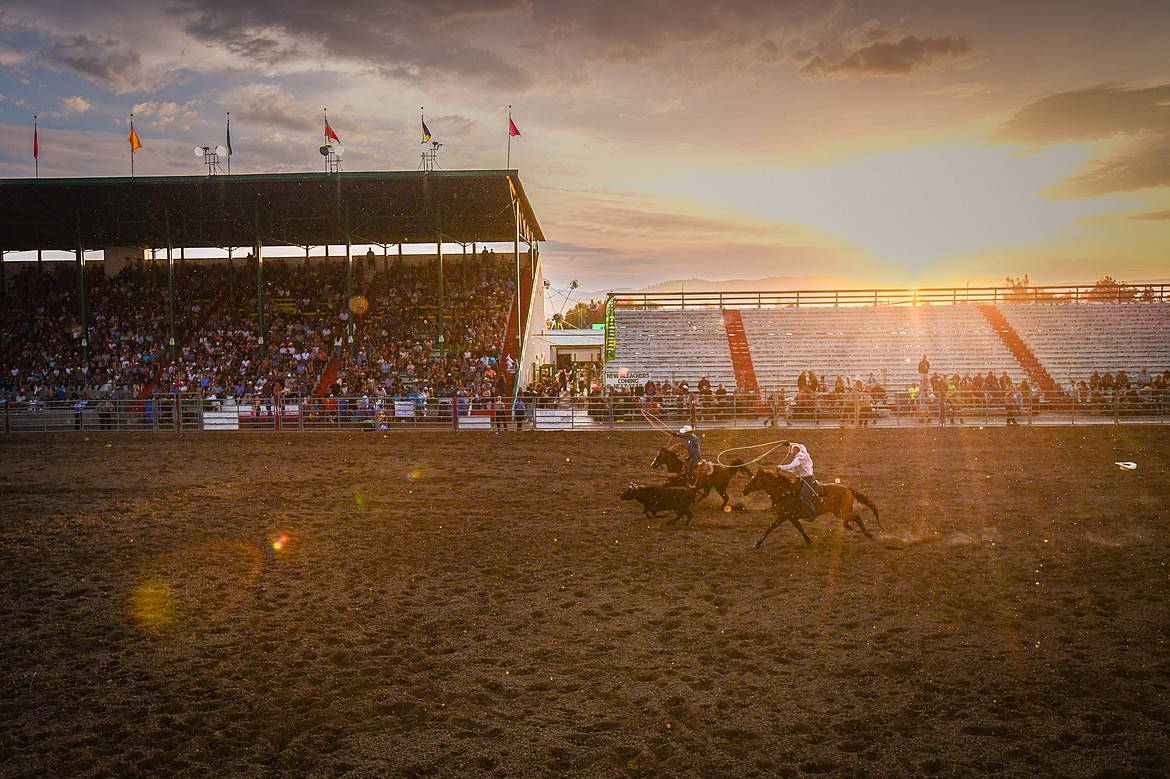 Chris Westphal, from Kalispell, and Chad Hunter, from Townsend, chase down a steer during team roping at the PRCA Rodeo at the Northwest Montana Fair & Rodeo on Thursday, Aug. 15. (Casey Kreider/Daily Inter Lake)