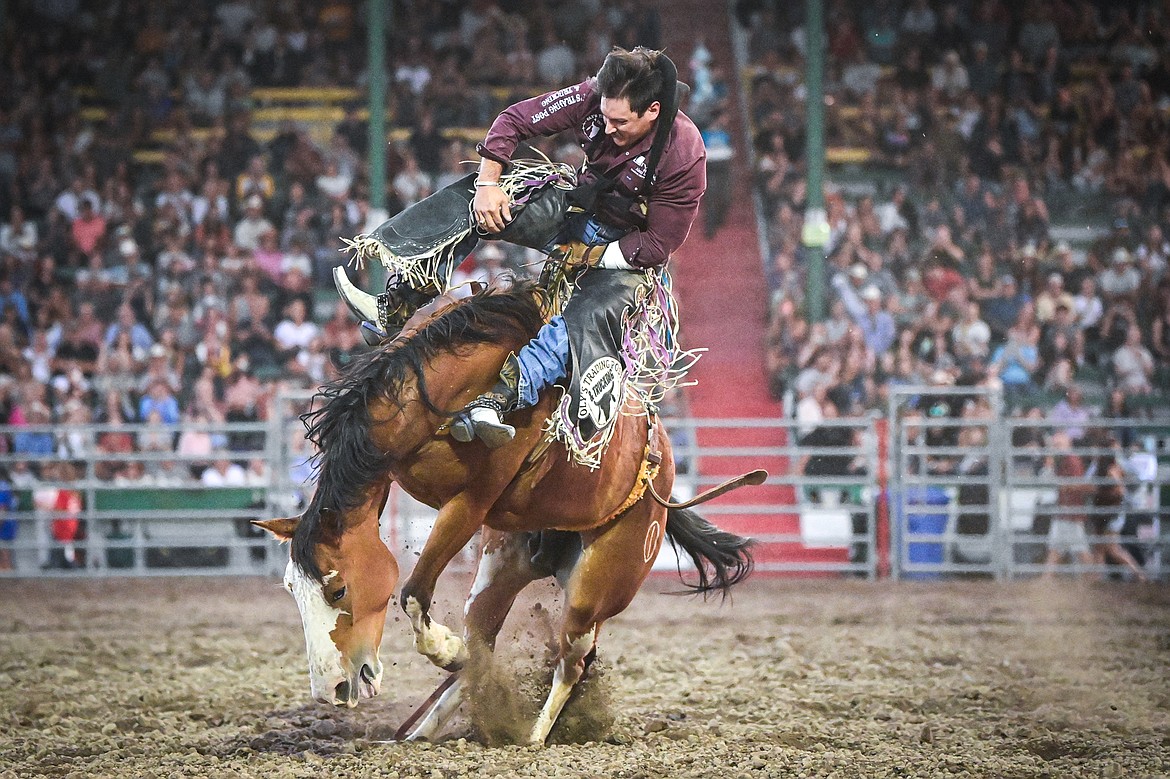 Ty Fast Taypotat, from Nanton, Alberta, Canada, holds onto his horse Crazy Legs during bareback riding at the PRCA Rodeo at the Northwest Montana Fair & Rodeo on Thursday, Aug. 15. (Casey Kreider/Daily Inter Lake)