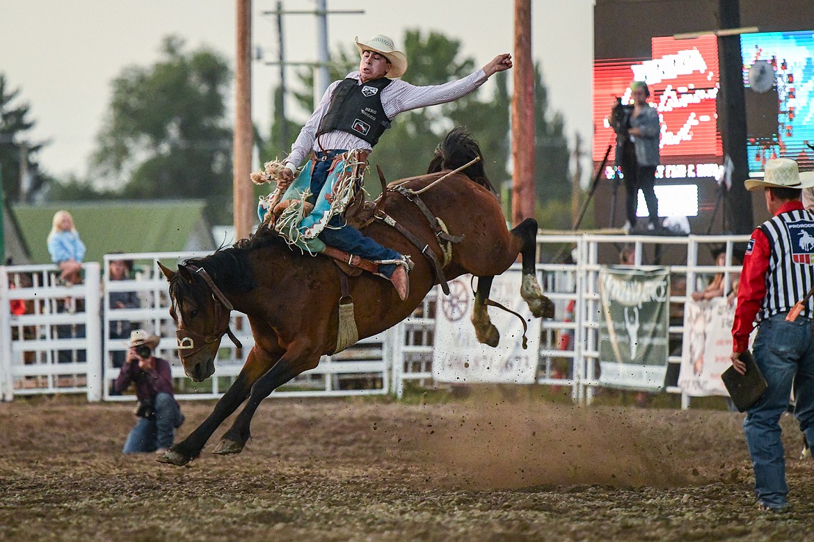 Kolby Kittson, from Browning, hangs onto his horse Extra Special during saddle bronc riding during the PRCA Rodeo at the Northwest Montana Fair & Rodeo on Thursday, Aug. 15. (Casey Kreider/Daily Inter Lake)