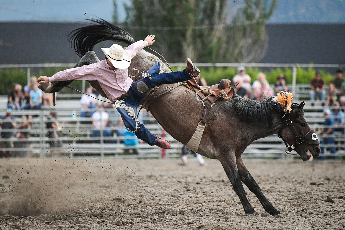 Bailey Bench, from Oakley, Idaho, gets bucked off his horse Gambler during saddle bronc riding at the PRCA Rodeo at the Northwest Montana Fair & Rodeo on Thursday, Aug. 15. (Casey Kreider/Daily Inter Lake)