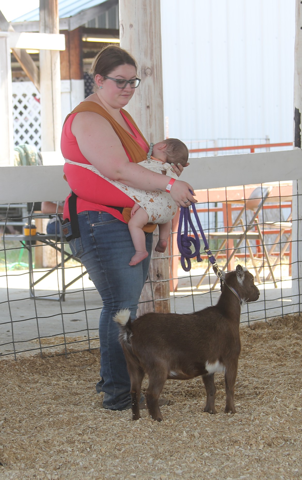 Jaycee Ducken has some help in the form of son Oliver, 6 months, as she competes in a goat category at the Bonner County Fair on Thursday.