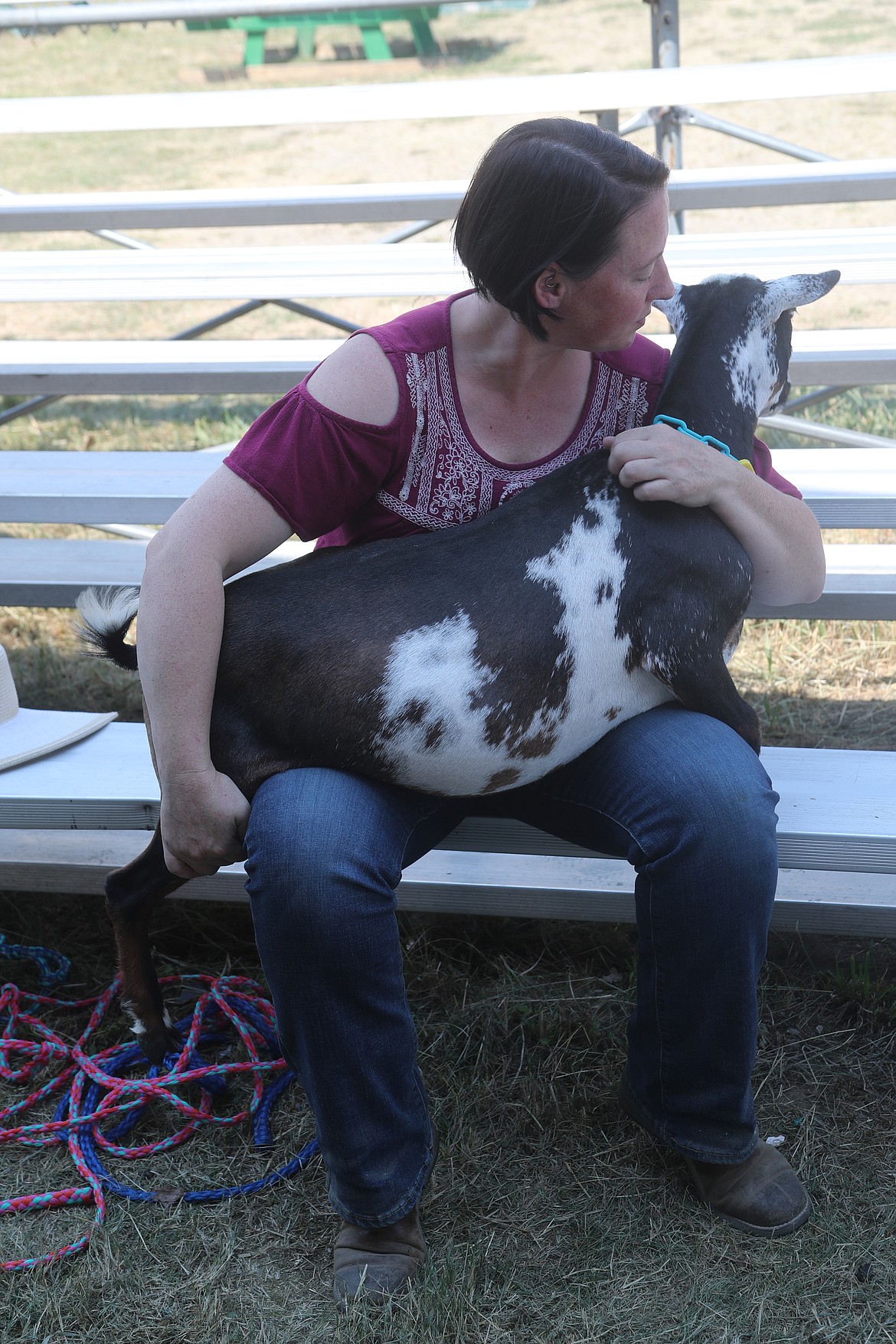 Laurie Hunt sits with Camaro while waiting for the start of a goat competition at the Bonner County Fair on Thursday.