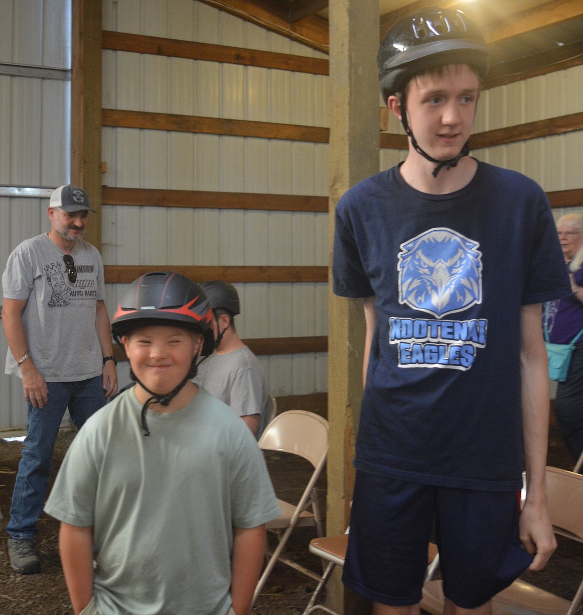 Mark Poncato and Ethan Starr get ready to mount horses at Harmony Ranch.