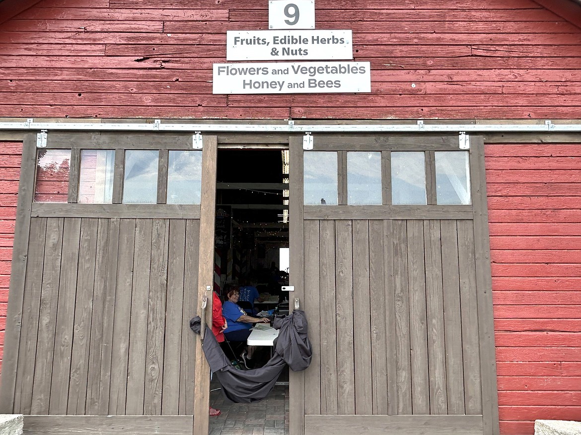 Juana Perley sits inside Building 9 during set up for the North Idaho State Fair on Thursday.