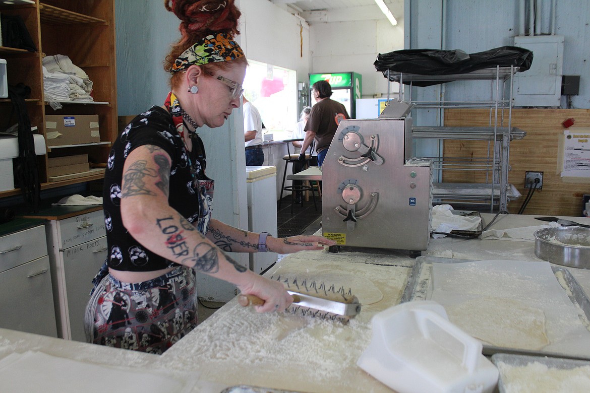 Jessica Moore prepares dough for the lion ears in the Moses Lake Lions booth at the Grant County Fair Thursday.